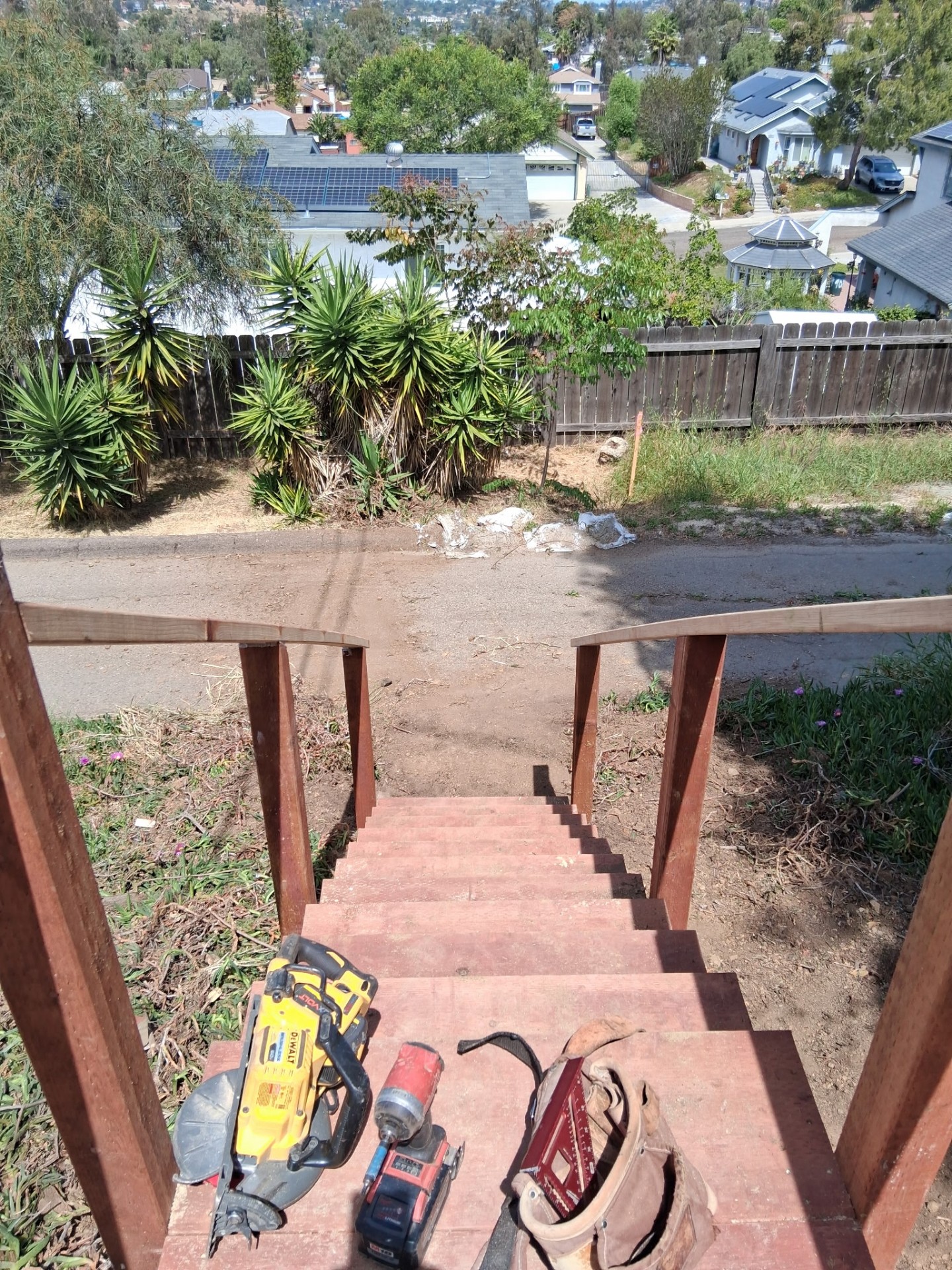 New wood staircase built down a steep San Diego hillside